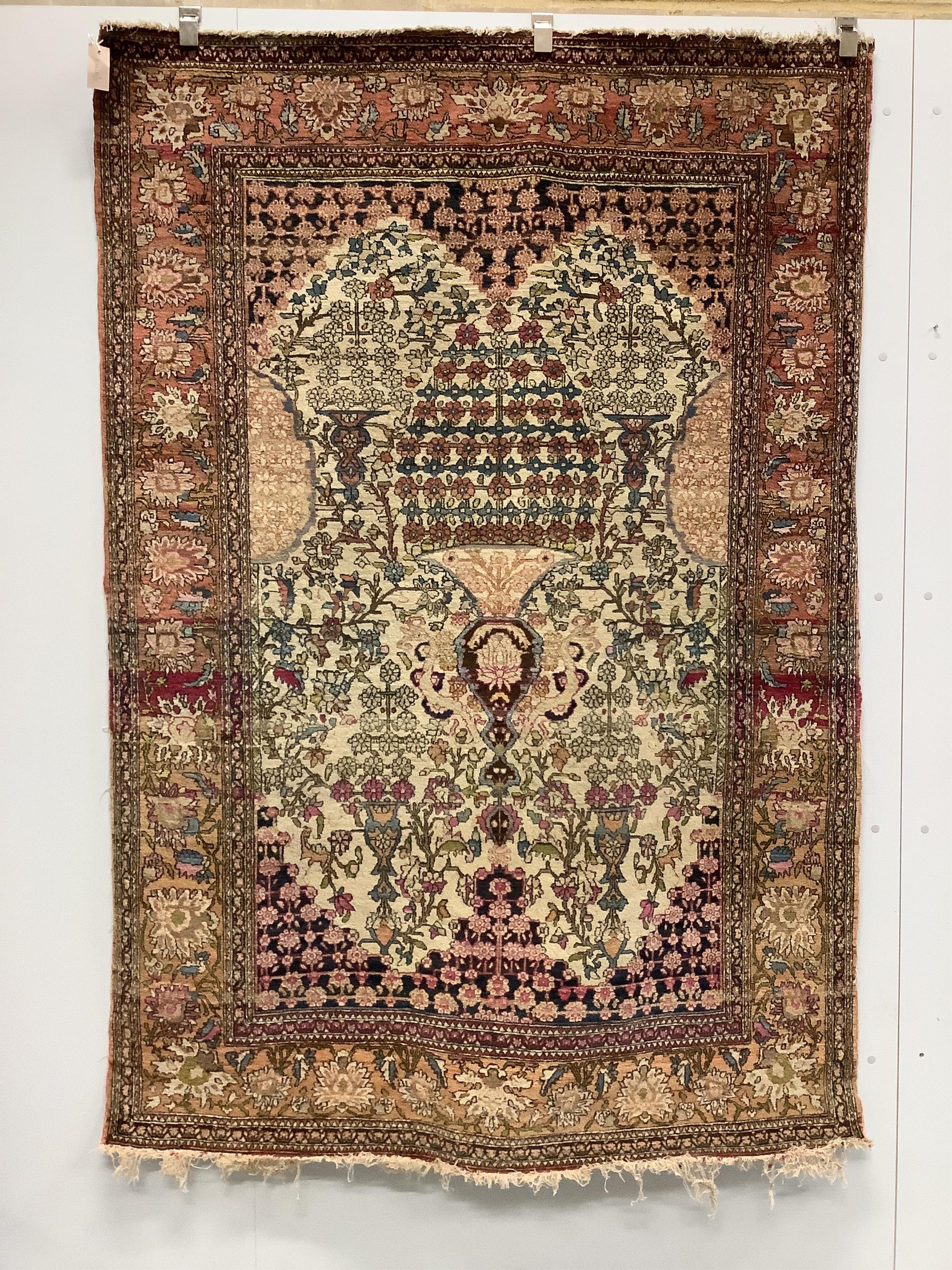 A North West Persian ivory ground rug, 200 x 139cm. Condition - poor to fair